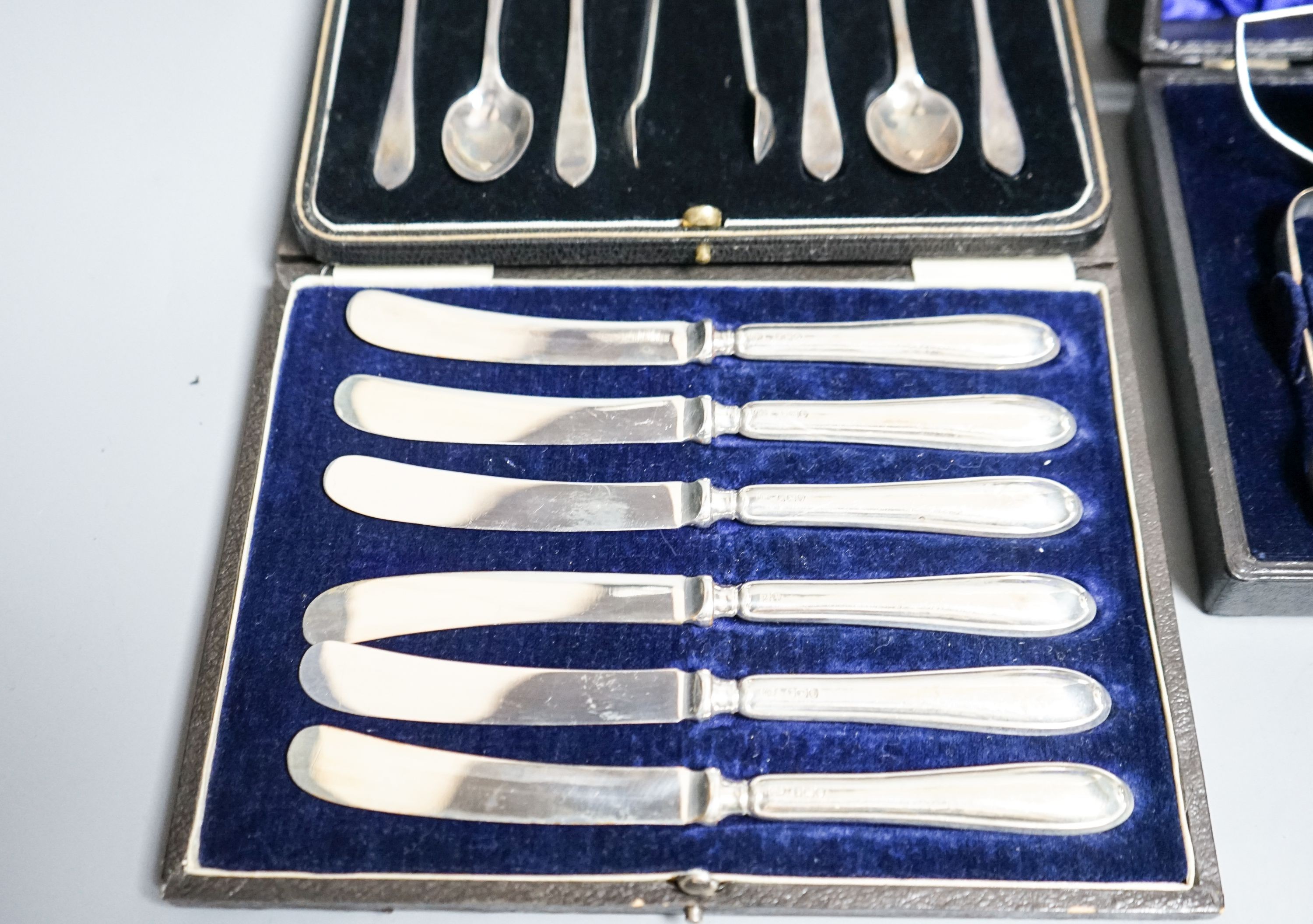 A cased Edwardian silver cream, sugar and sugar tongs, Birmingham, 1901 and two other cased sets of silver cutlery.